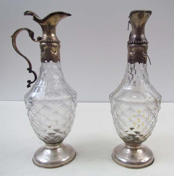 Pair of English cut glass and silver clarets: Artist: Attributed to William Shaw Date: 18th century Medium: glass and silver clarets Dimensions: 8 inches tall Signature: tops marked William Shaw London 1773
