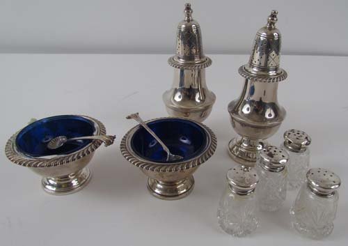 Assorted Pairs of Sterling Salt & Pepper Dispensers: Title: Assorted Pairs of Sterling Salt & Pepper Servers including 2 Sterling Towers, 2 cobalt glass and sterling cellars with shell spoons, & 4 small cut glass with sterling tops Medium: sterling silv