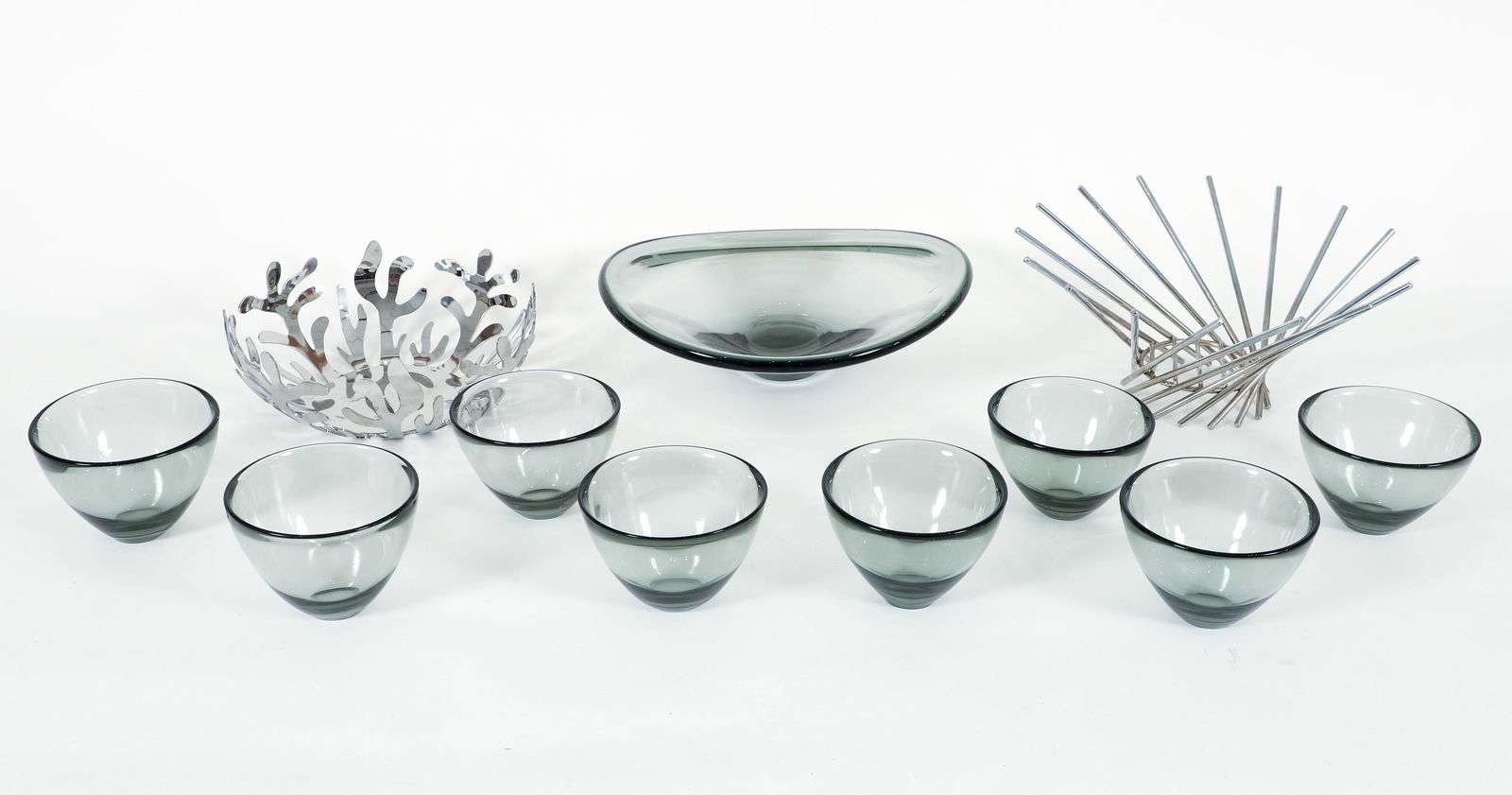 Lot of 11, Lutkin for Holmegaard Glass Bowls, Alessi Bowl: Group of 11 bowls. 9 Per Lutkin (Danish, 1916-1998) for Holmegaard smoked glass bowls. 1 'Selandia' center bowl, 1956, 4 x 12.5 x 12.25 inches. 8 smaller bowl, 3.75 x 5 inches. All with appropriate in