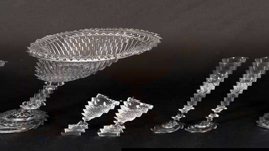 Crystal Compote, 2 Bakewell Champagne Flutes, 2 Salt Cellars: Lot of 5 pieces. Includes: early 20th century gadrooned crystal clear compote, 8.75 x 12.5 inches; 2 clear diamond cut pedestal boat form salt cellars, 3.5 x 3.5 x 2.5 inches; 2 Bakewell clear cut