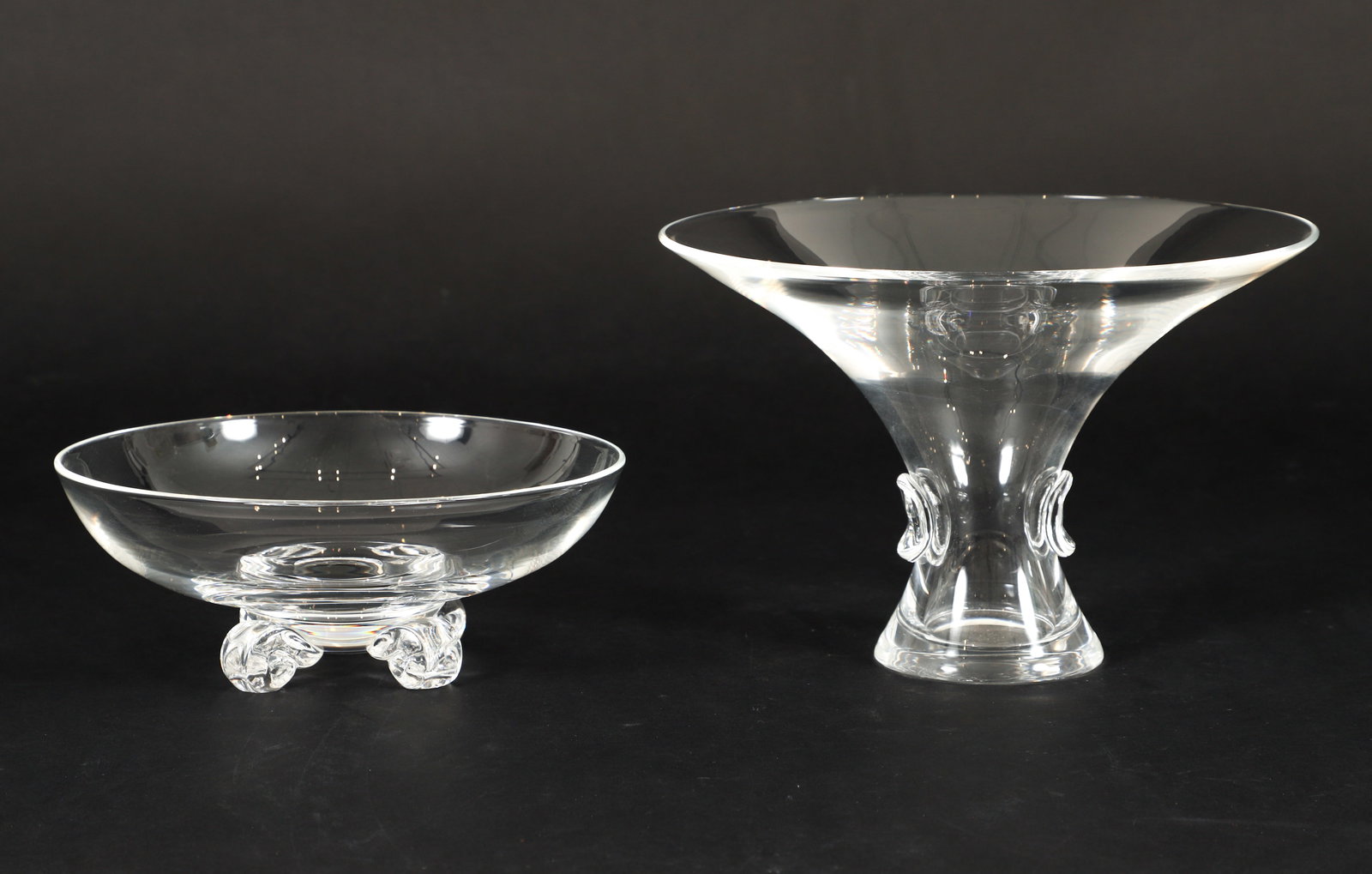 2 pc Steuben Footed Bowl and Trumpet Bouquet Vase: 2 pc Steuben glass vase and bowl. Trumpet bouquet vase designed by George Thompson for Steuben, pattern No. 7985, incised "Steuben" on underside, measures 6 x 9 inches. Four footed crystal glass bowl,