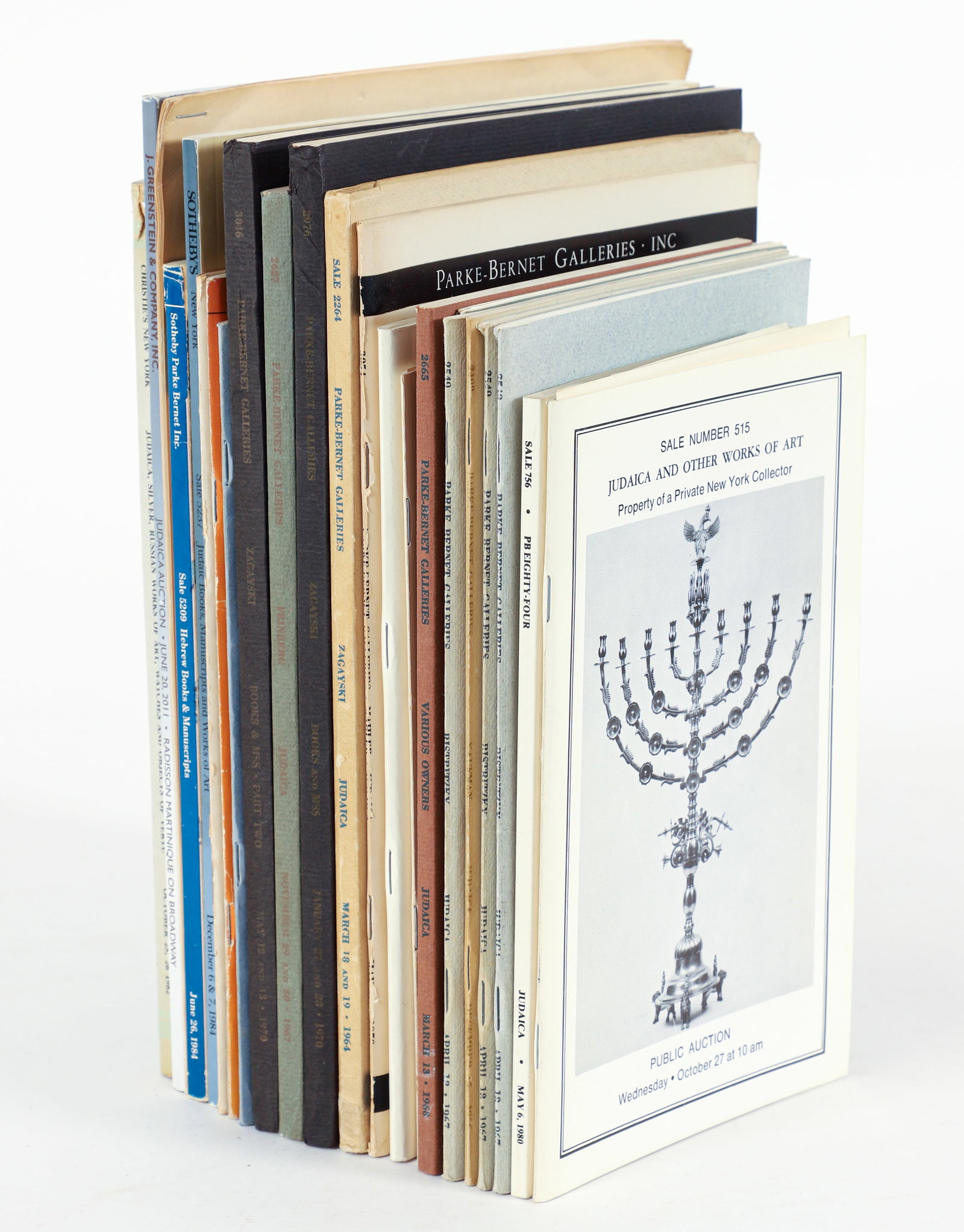 Lot of 24 Judaica Auction Catalogs mostly 1980s: Lot of 24 Auction Catalogs, all for Judaica sales, mostly 1980s, primarily Sotheby's and Parke-Bernet, all softcovers, some with price-list laid-in.