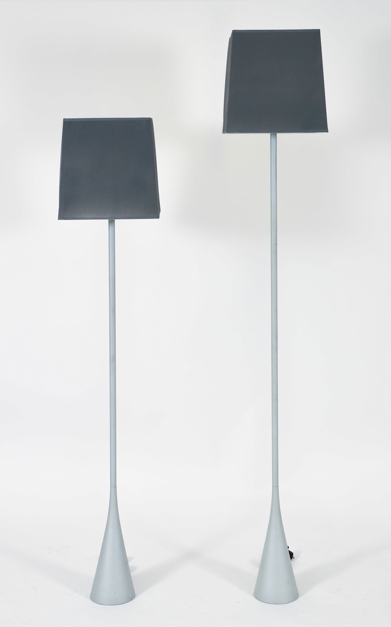 2 Pascal Mourgue for Cinna Ligne Roset Floor Lamps: 2 Pascal Mourgue (French, 1943-2014) for Cinna + Ligne Roset floor lamp and reading lamp, Saint-Jean le Vieux, France, 1990s. Matte silver metal flute-form weighted floor lamps. Molded signatures at b