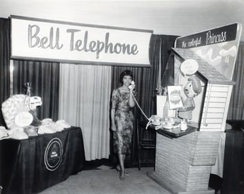 Teenie Harris photo Doris Mixon demonstrating Princess phone at home show