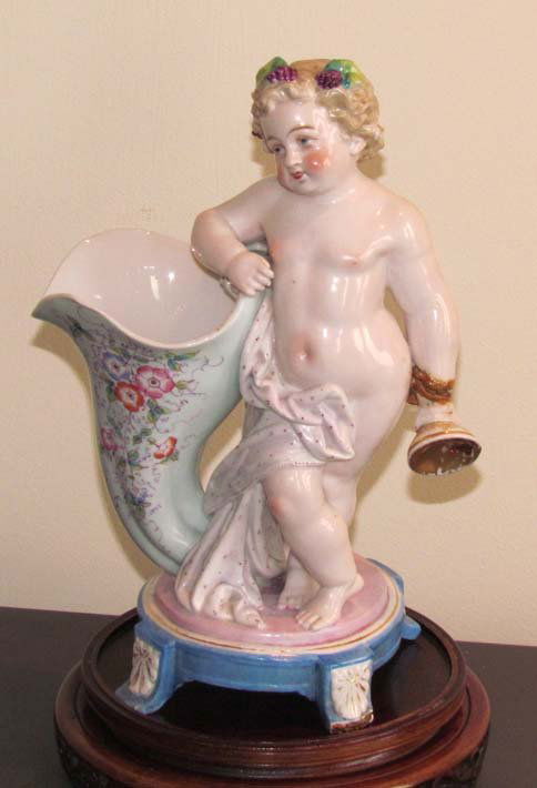 KPM Glazed Porcelain Silenus Figure: Title: KPM Glazed Porcelain Silenus Figure holding an empty wine glass Medium: glazed porcelain Dimensions: 10.5 x 7 x 4.5 inches Provenance: The Estate of Rita Martin Green