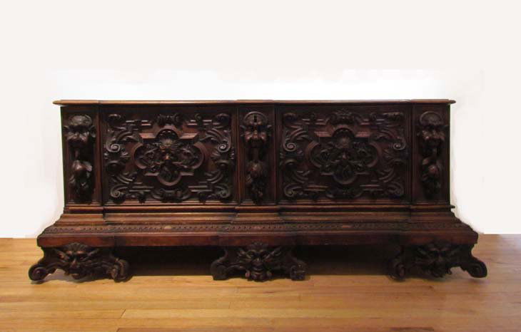 A Good Continental Baroque extensively carved Coffer C: Artist: European Continental Furniture Craftsman Title: An extensively carved Coffer Chest with elaborately scrolled decoration and carved gargoyle heads on face and scrolled feet and fruit swags Date