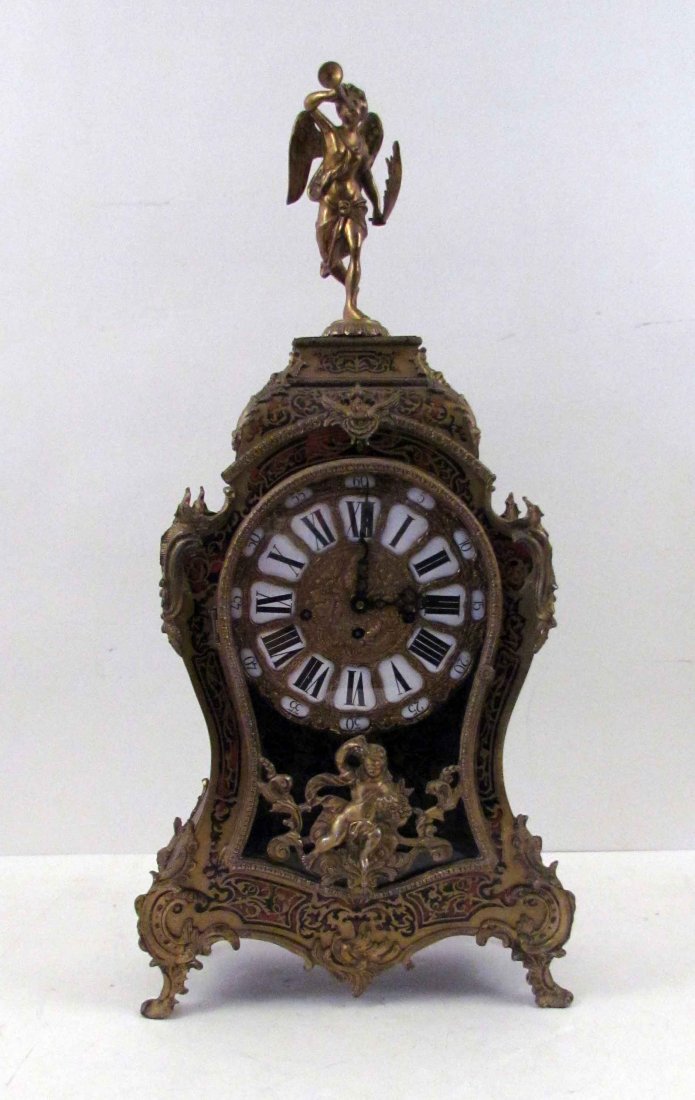 Louis XV Style Faux Tortoise Shell Ormolu Clock: Artist: Style of Charles Andre Boulle (1642-1732) Title: Louis XV Style Faux Tortoise Shell Ormolu and Part Ebonized Clock in the Style of Charles Andre Boulle, mounted with figure on top blowing a ho