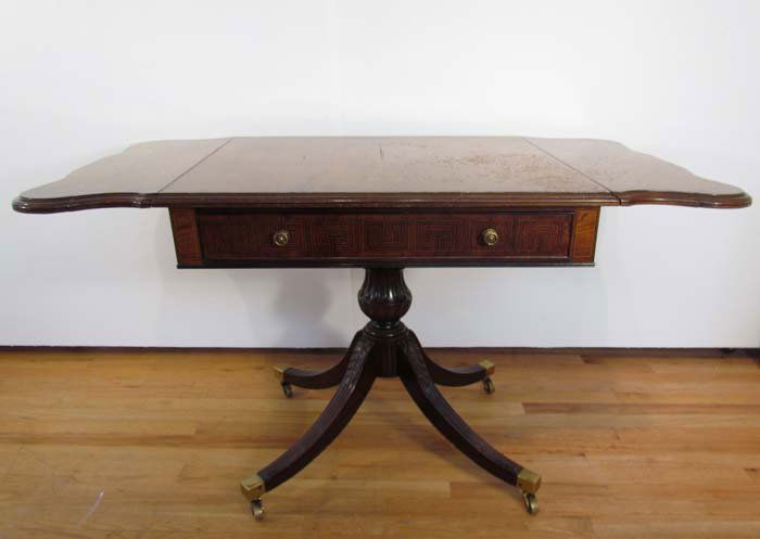 Duncan Phyfe Style Antique wood side table with 2 drop : Title: Duncan Phyfe Style Antique wood side table with 2 drop leaves, acanthus carved sabre legs with brass toe caps and castors, drawer Medium: mahogany Dimensions: 29 x 48 x 26.25 inches