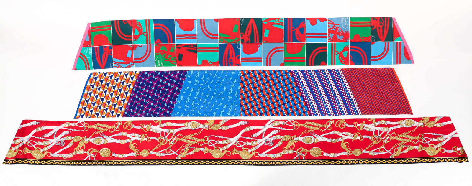 3 Hermes Silk Maxi Twilly Cut Scarves by Hugo Grygkar: 3 Hermes Scarves by Hugo Grygkar: Brides de Gala, orange and red scarf, 8 x 84 inches. Brides de Gala, red and green scarf, 8 x 62 inches. Ex Libris, purple and orange scarf, 8 x 62 inches. All maxi t