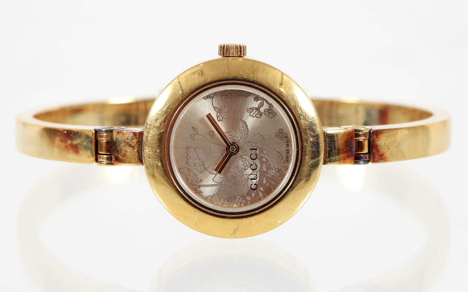 Gucci 105 Series Flora Womens Wristwatch: Gucci 105 Series Flora Womens Wristwatch, gold plated stainless steel, marked "Gucci Stainless Steel" at back of face with series number 105 and serial number 10581143, made in Switzerland, 3atm water