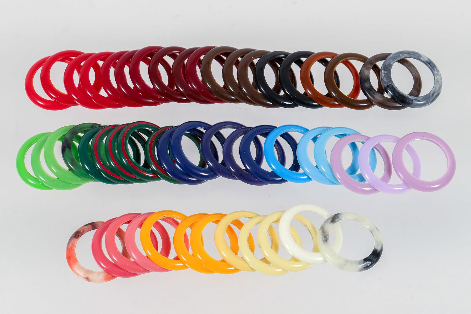 51 pc Gucci Watch Change Bezel Extras: 51 Piece Gucci Change Bezel Extras, includes 4 Gucci stripe bezels, 5 marbled bezels, and various solid colors, acrylic, most labeled "Gucci A.A. Swiss Made," some unmarked, approx. 1 inch diameter. B