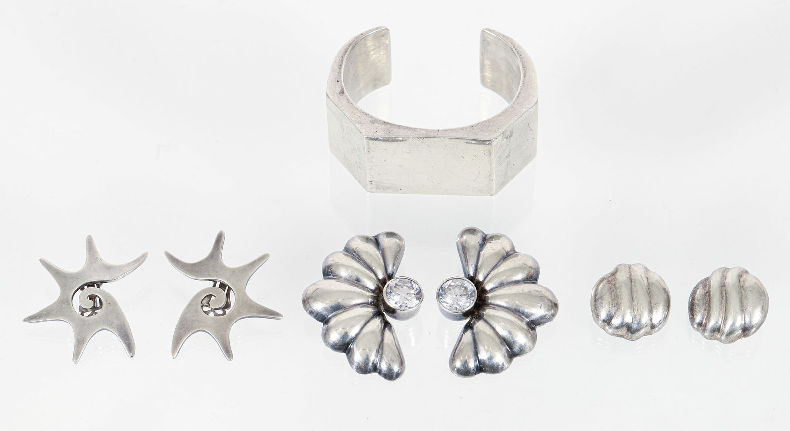 Mexican Taxco Sterling Geometric Cuff Bracelet 3 Pr Sterling Clip On Earrings: 4 pieces of sterling silver jewelry. Includes: Mexican Taxco Geometric Cuff Bracelet, sterling silver, marked "Mex 925 TL-34," width measures 1.25 inches, inner circumference measures 6.75 inches, 86.