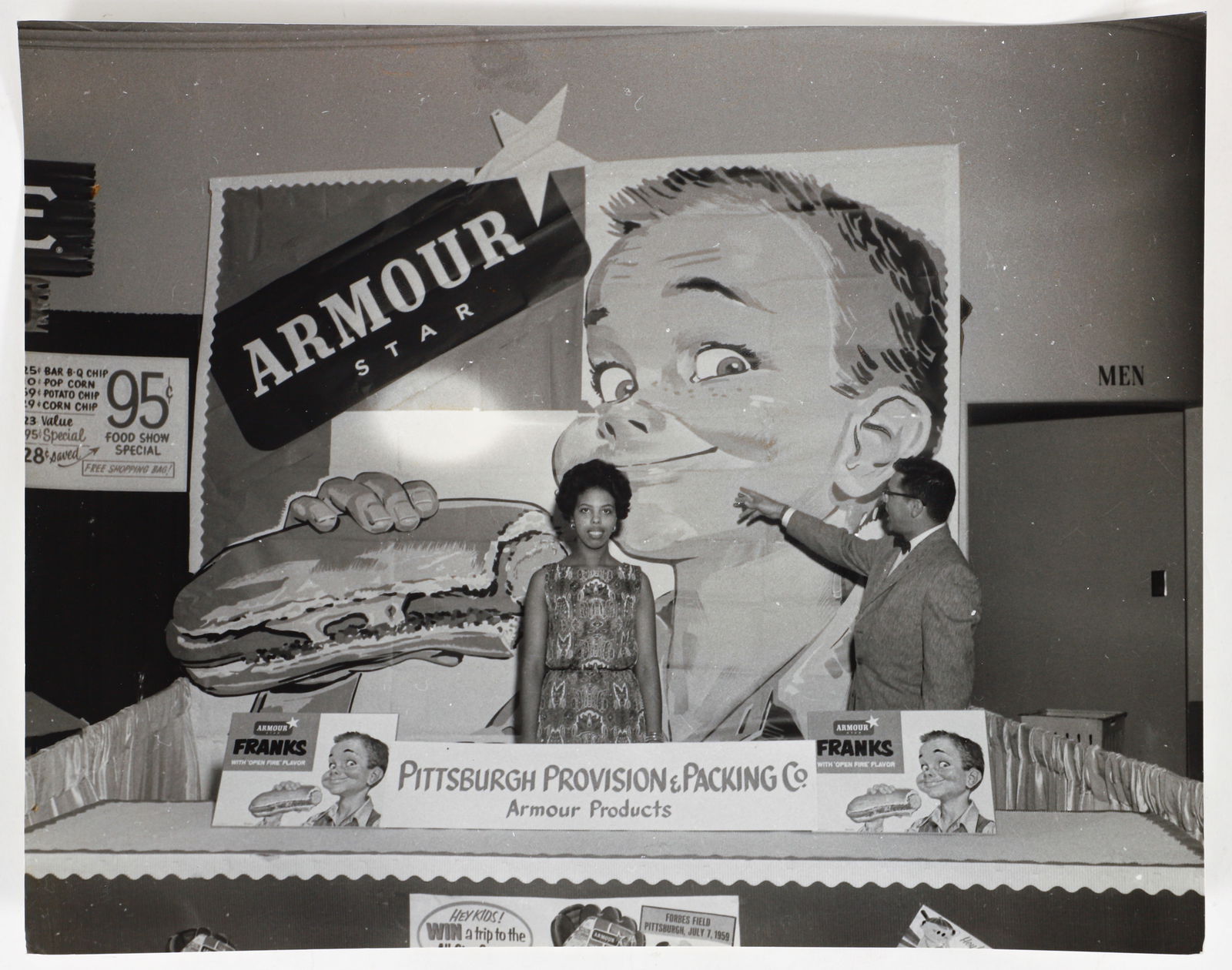 Teenie Harris photo Rosalyn Bunnie McPherson in Pittsburgh Provision and Packing Company booth: Harris, Charles (Teenie) (American/Pittsburgh, 1908-1998), Rosalyn ?Bunnie? McPherson and man in Pittsburgh Provision and Packing Company booth advertising Armour franks, originally photographed at 19