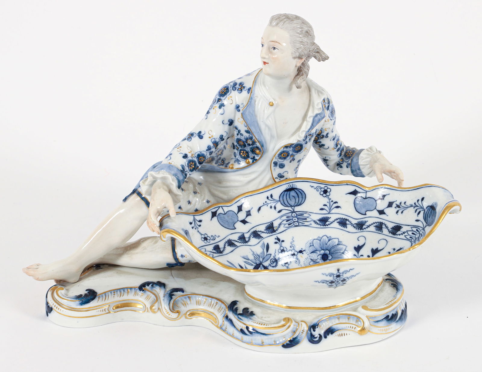 Meissen Gallant Figural Sweetmeat Dish: 19th C. Meissen porcelain recumbant male figure holding a sweetmeat dish in the Blue Onion pattern. 19th C. crossed swords mark in underglaze blue, with 63 in underglaze blue below crossed swords and