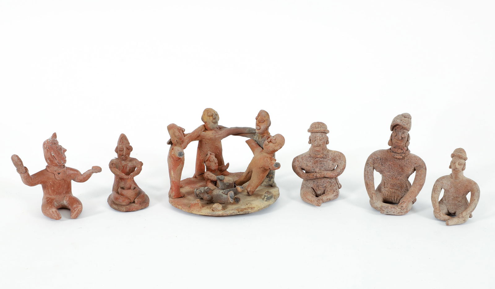 6 Pre-Columbian Seated Effigy Figures: Collection of 6 Seated Effigy Figures, pre-Columbian, c. 150 BCE - 200 CE or in the style of, Western Mexico, Colima or Jalisco States, includes 1 sculpture of multiple figures on round base and 5 sea