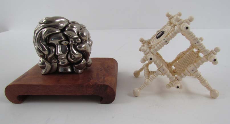 Ivory Geometric Construction and Metal Puzzle: Title: Ivory Geometric Construction and Metal Puzzle with Woman's face Medium: ivory, metal Dimensions: ivory: 3 x 4 x 4.25 inches Provenance: The Estate of Herbert Seigle