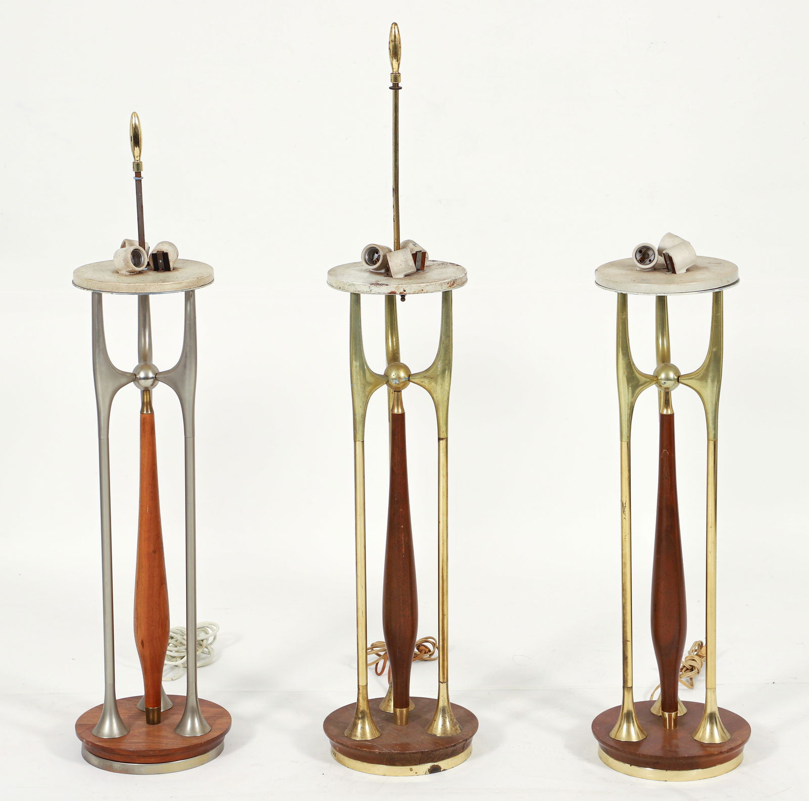 3 Gerald Thurston for Laurel Walnut and Brass Tall Table Lamps: 3 Gerald Thurston (American, 1914-2005) for Laurel walnut and brass tall table lamps, USA, mid 20th century. Each with three brass rods surrounding a center shaped walnut center element. 2 in brass, 1