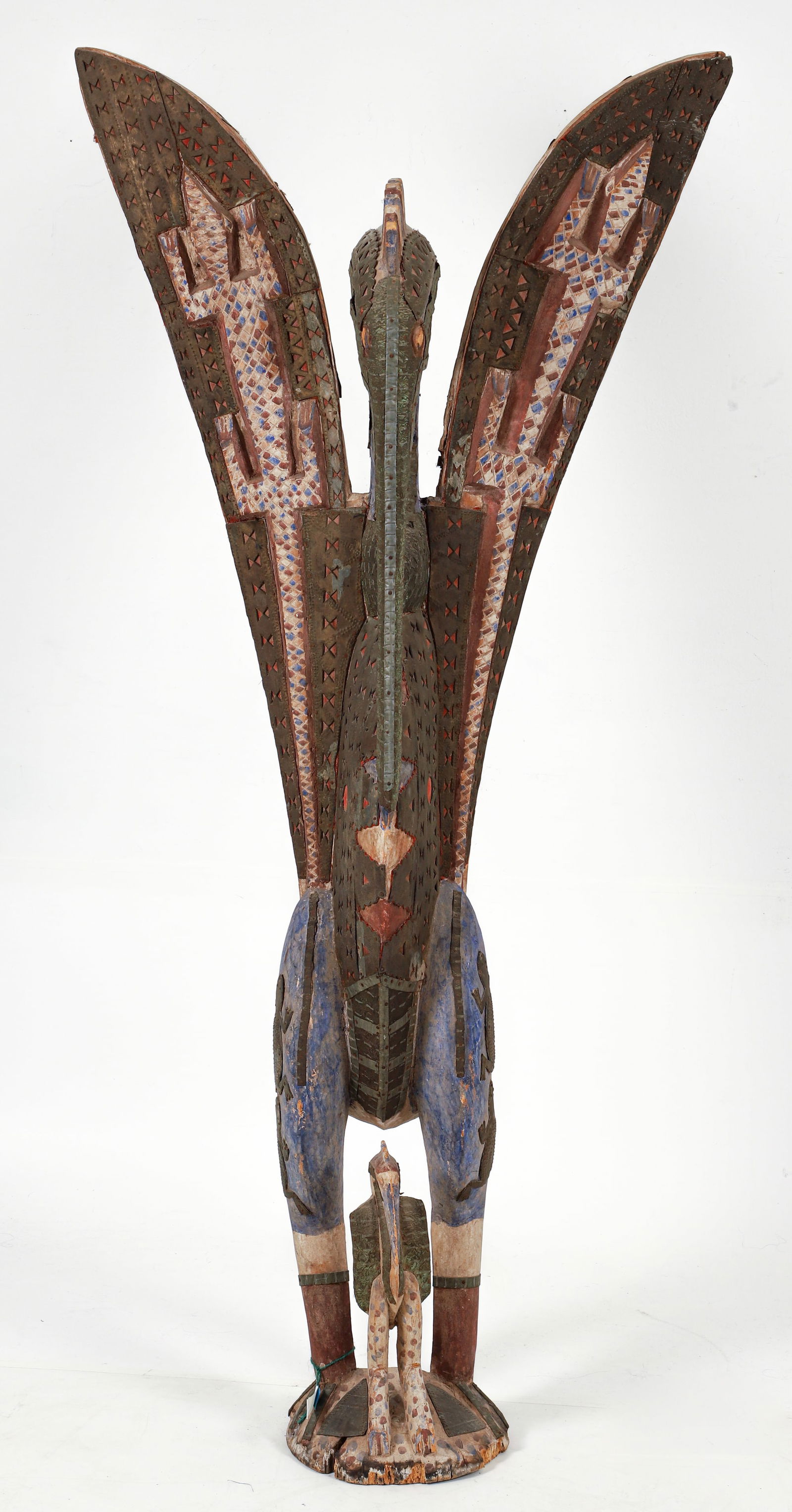 Monumental Senufo Hornbill Bird: Monumental hornbill bird, Senufo peoples (or after), Ivory Coast. Carved wood figure with hammered tin, aluminum. The wings and body are covered with what seem to be individually cast brass pieces.