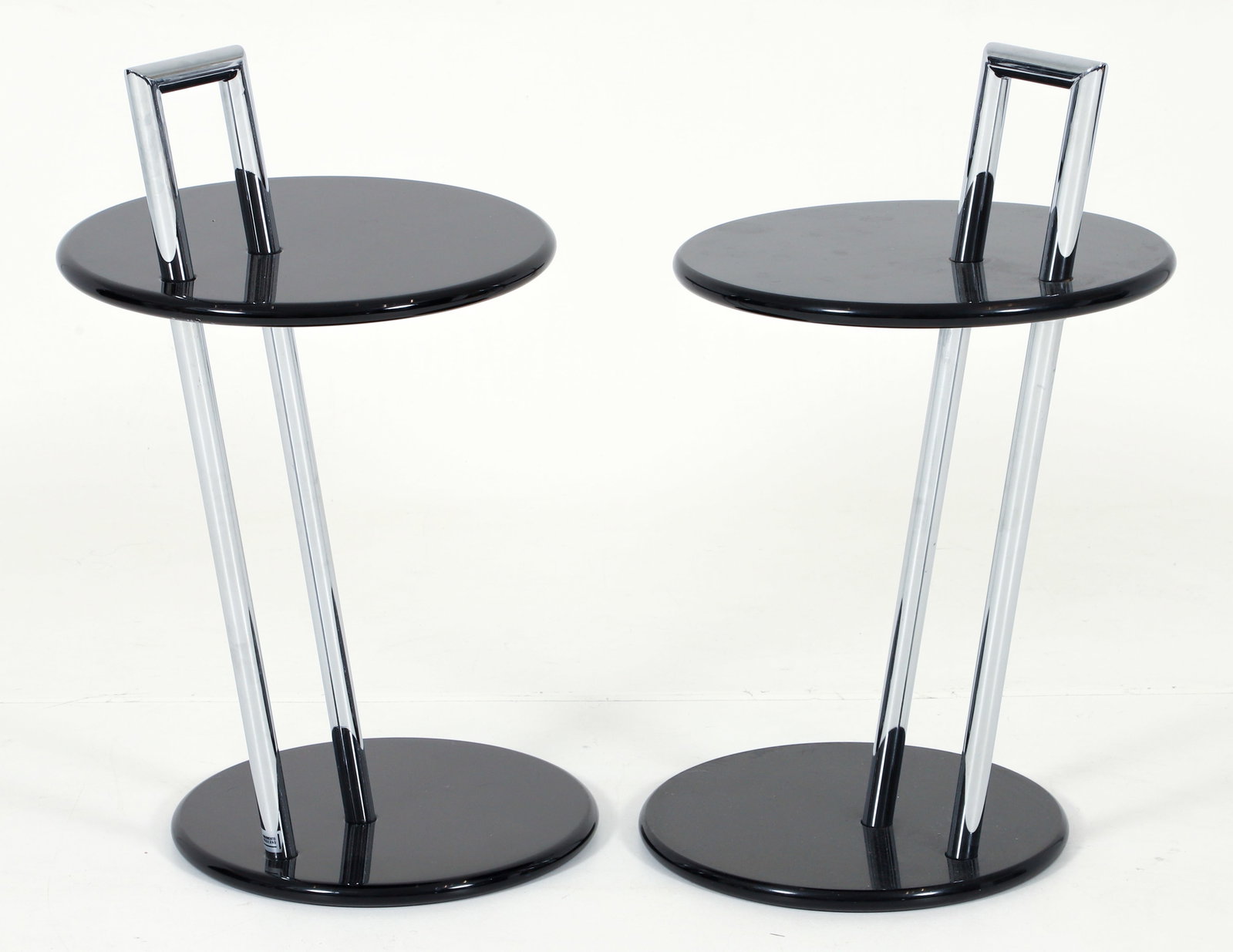 Pair of Eileen Grey Style 419 Side Tables: Pair of Eileen Grey model 419 side tables, first designed in 1927. Chromed tubular steel frame, base and top in a black lacquer finish. Labeled Movimento Moderno. Both 27.75 x 19 x 15.75 inches.