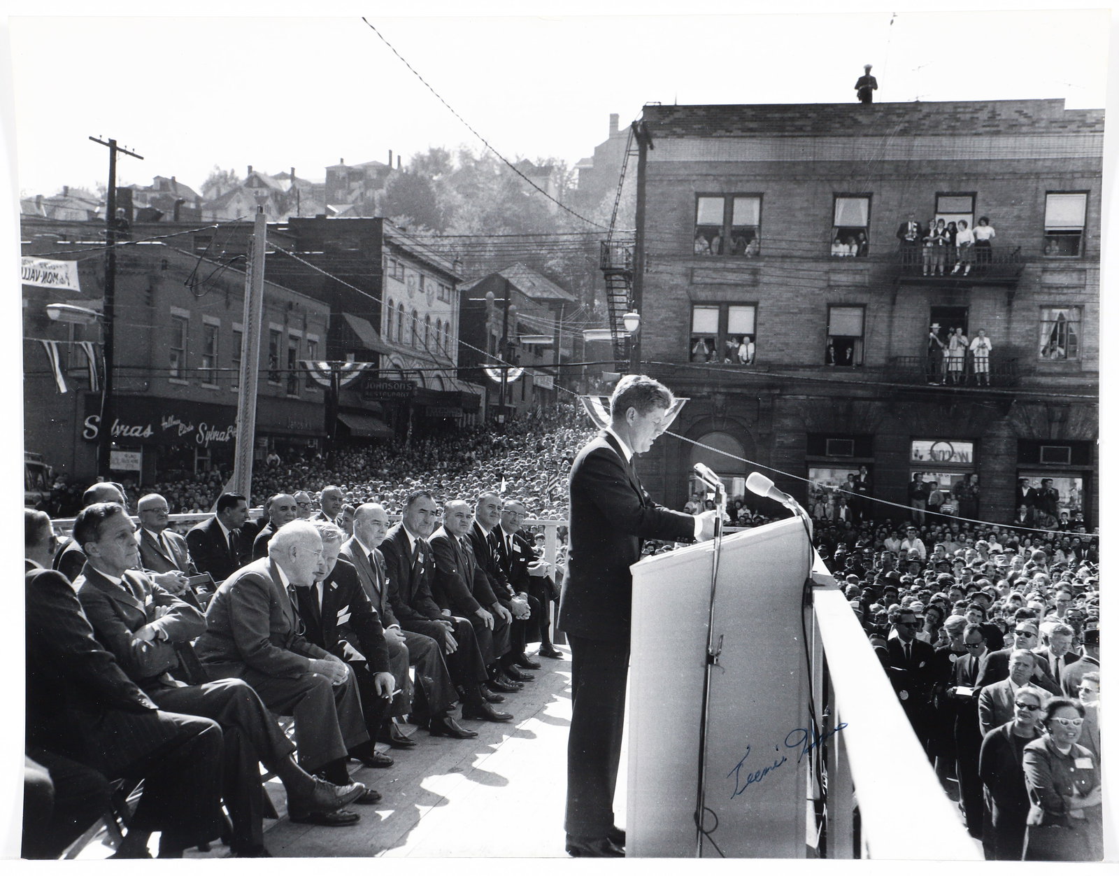 Charles Teenie Harris Signed Photo JFK in Monessen 1962: Harris, Charles (Teenie) (African-American/Pittsburgh, 1908-1998), President John F. Kennedy speaking at a podium to a crowd with Rosenson?s furniture store in background, Monessen, Pennsylvania, take