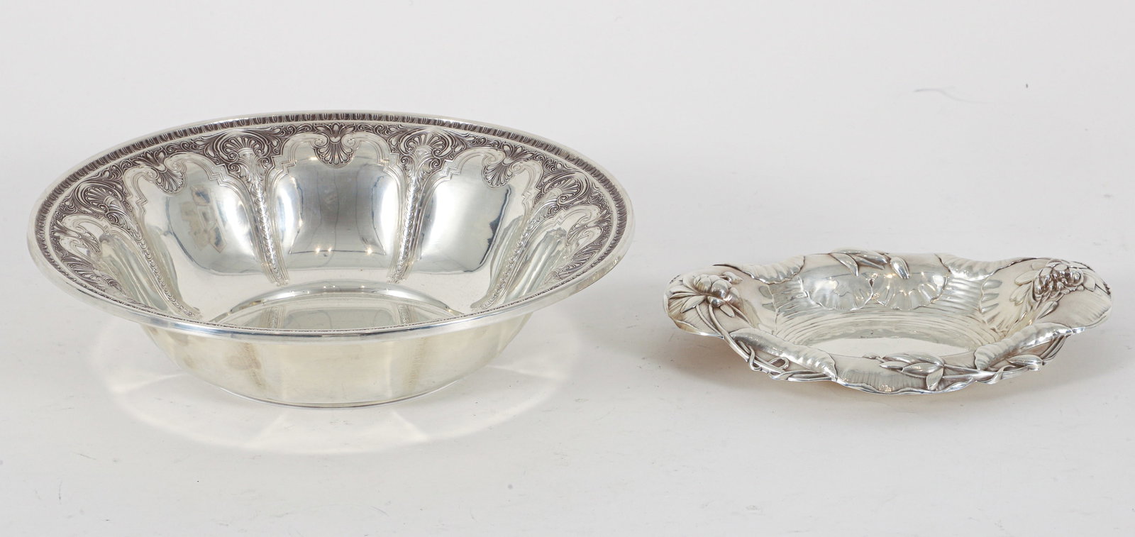 Gorham Silver Lily Pad Dish and International Sterling Bowl: Gorham repose lily pad motif sterling dish together with an International sterling scallop motif bowl. 2.5 x 10 inches and 1.25 x 7.5 x 5.5 inches. Total weight approximately 15.39 ozt.