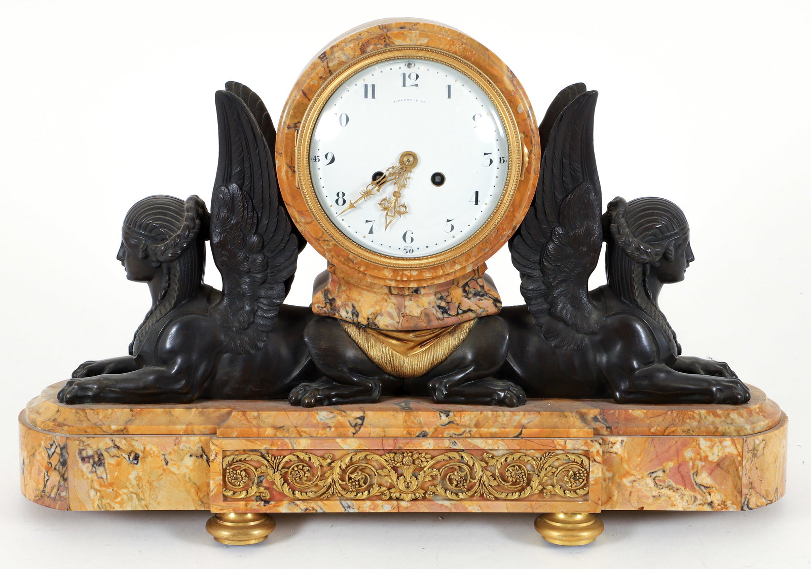 French Egyptian Revival Mantel Clock Retailed by Tiffany & Co.: Egyptian Revival mantel clock retailed by Tiffany and Company, French, late 19th century. Rose marble base, enamel face, flanked by two outturned sphinx. The movement is stamped CH Hour, Made in