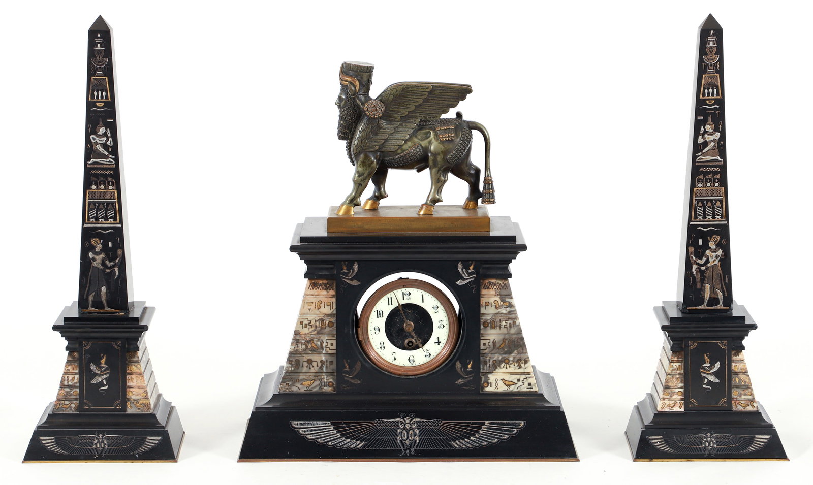 Egyptian Revival Marble Garniture Clock Set: Egyptian Revival marble garniture clock set, French, 19th century/early 20th century. Central clock is surmounted by an Assyrian Lamassu. Obelisks feature stylized hieroglyphic decoration. Movement