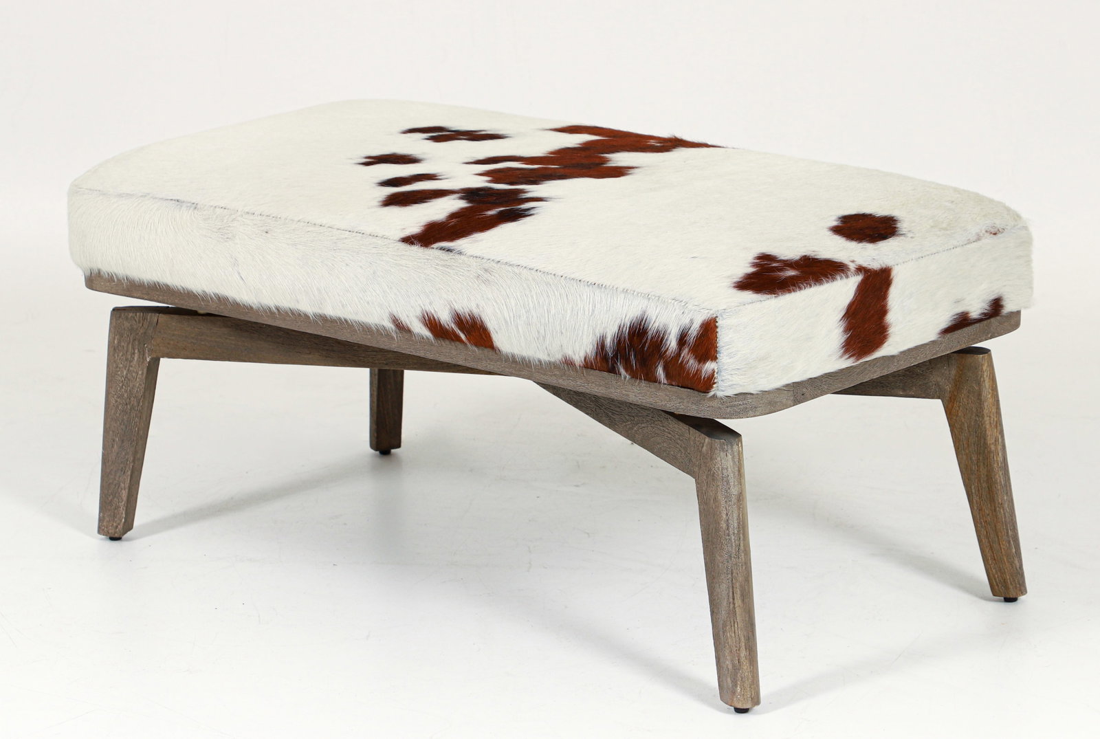 CB2 Contemporary Cowhide Bench: CB2 Contemporary cowhide bench, made for the American market, 2018. Grey finish base with brass tone spacers. Appropriate labels at underside. 16.5 x 36.5 x 18 inches.