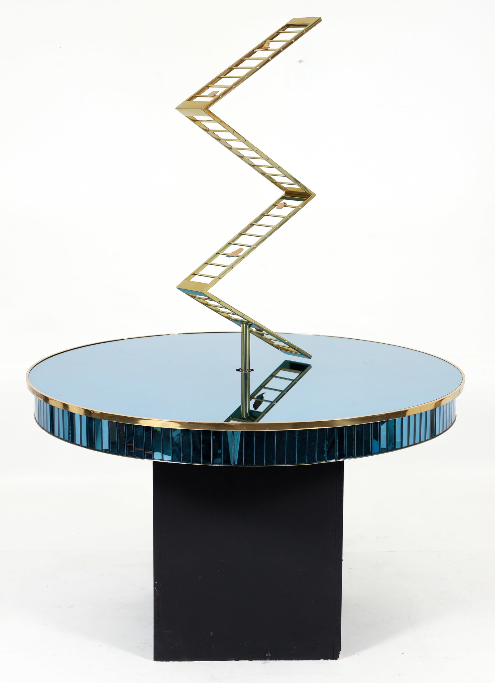 Francis Nowalk Blue Mirrored Pedestal Table: Francis J. Nowalk (American/Pittsburgh, PA, 1928-2024) custom designed blue mirrored pedestal table. Wooden black painted base, faceted blue mirrored edge, gold metal trim. Gold tone metal
