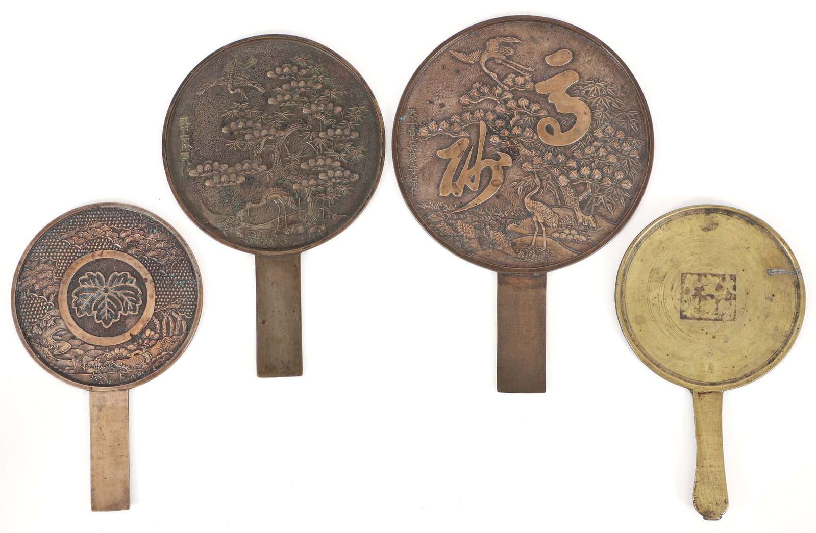 4 Chinese bronze and brass decorated mirrors: Bronze and brass mirrors with relief decoration on the reverse sides, largest being 12 inches long.
