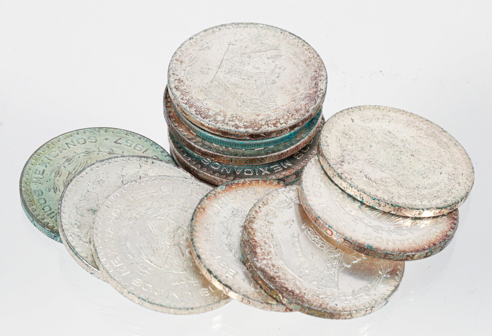 13 Mexican One Peso Coins: 13 One Peso Coins silver weighing approximately 0.0514 ozt. each. Please Note: Payment for this lot (and all other coin, gold and silver lots) can only be made by Wire/ACH Transfer, cashier's check or