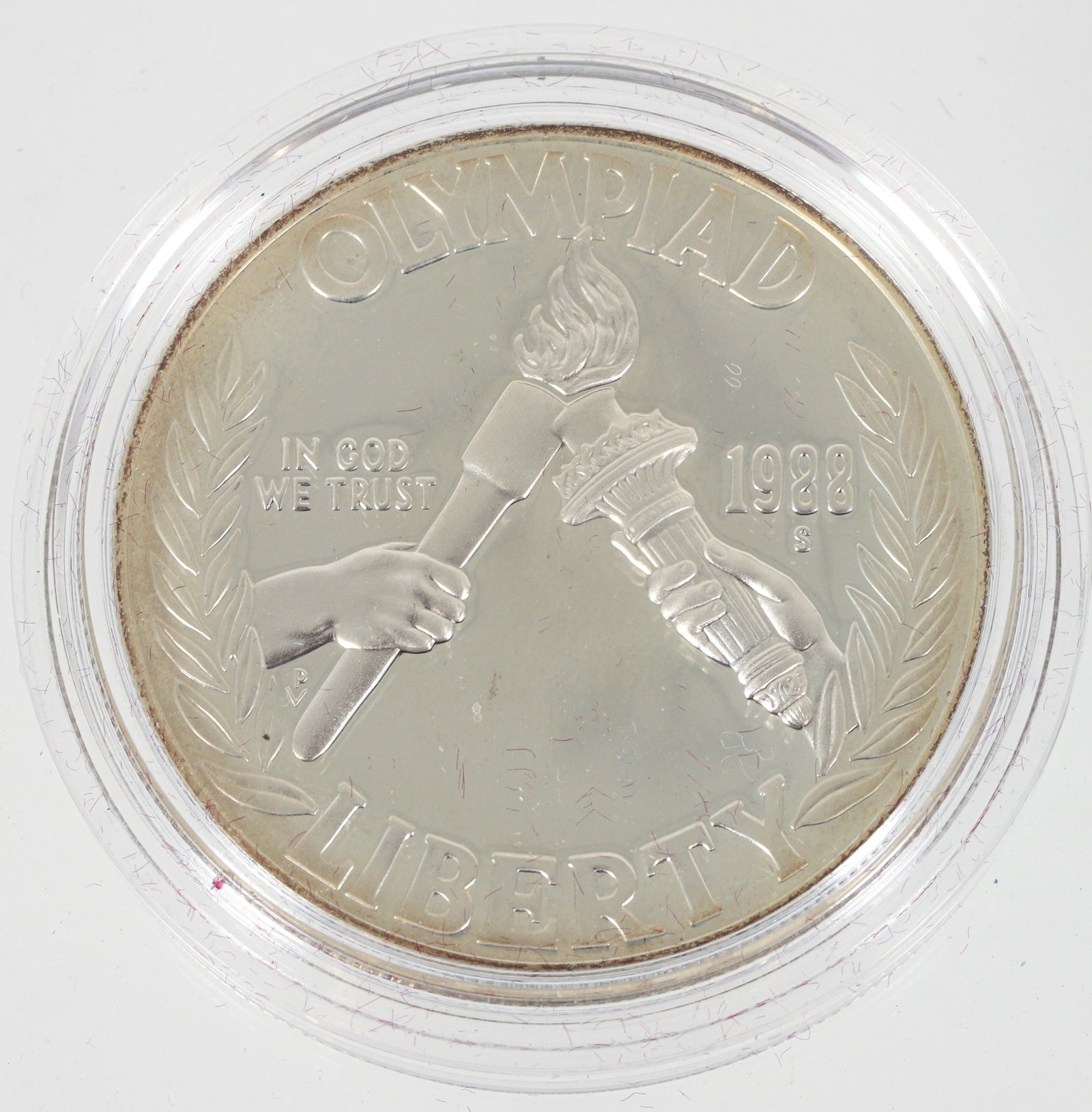 1988 United States Mint Olympic Proof Silver Dollar: 1988 United States Mint Olympic Proof Silver Dollar produced to commemorate the Olympics. The coin weighs 34.36 grams (in plastic case ) and consists of 90% silver. It includes an official clamshell c
