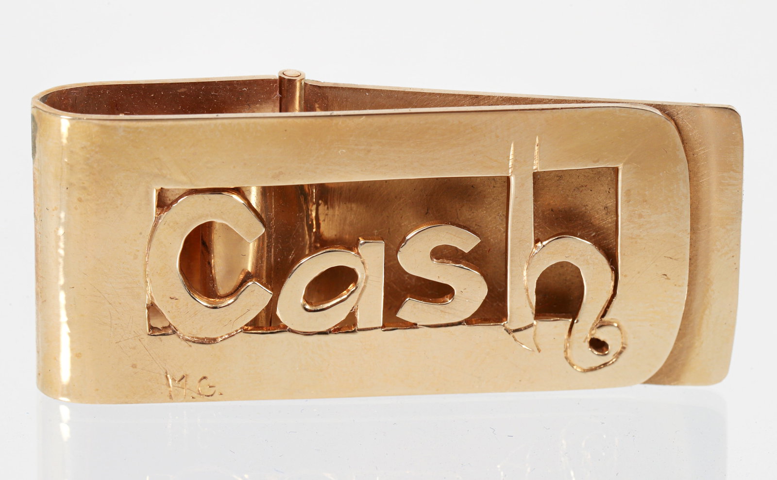 14K Gold Cash Money Clip approximately 30 grams: 14K Gold Cash Money Clip, etched 14K, M.G. and $. Weighs approximately 30.1 grams. Measures 2 inches wide. Please Note: Payment for this lot (and all other coin, gold and silver lots) can only be made