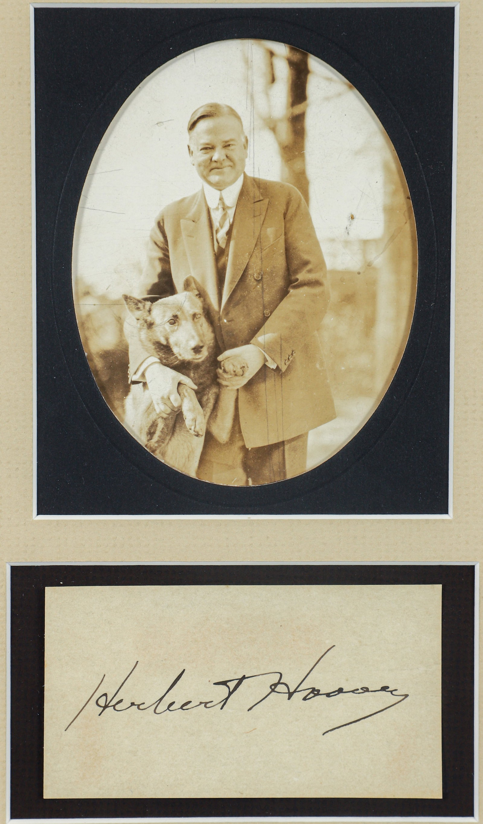 Herbert Hoover Autograph with Vintage Photograph: President Herbert Hoover (1874-1964), 31st President of the US, ink signature, framed together with a vintage photo posed with his dog, framed 12.5 x 8.5 inches.