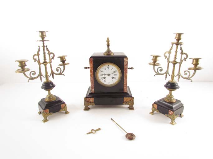 3 piece French marble mantle clock garniture set: Title: 3 piece French marble mantle clock garniture set Date: 19th century Medium: brass, slate, and red marble Dimensions: clock 12 x 7 x 4.5 inches, candelabra 14 x 4 x 3.25 inches