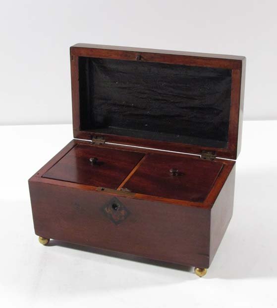 Georgian mahogany double tea caddy with brass feet and : Title: Georgian mahogany double tea caddy with brass feet and inlaid escutcheon Date: c. 1820's Medium: mahogany wood and brass Dimensions: 7.75 x 4.25 inches