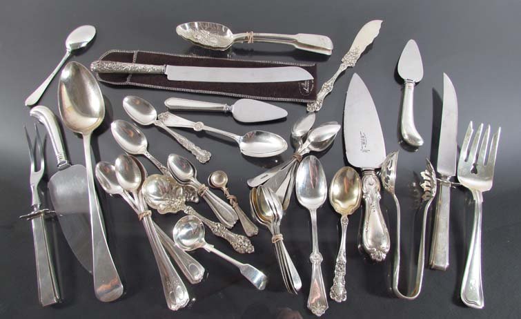 Assorted group of sterling silver serving utensils: Title: Assorted group of sterling silver serving utensils and flatware including tongs, berry spoons, carving set, teaspoons, coffee spoons, with assorted silverplate utensils Medium: sterling Dimensi