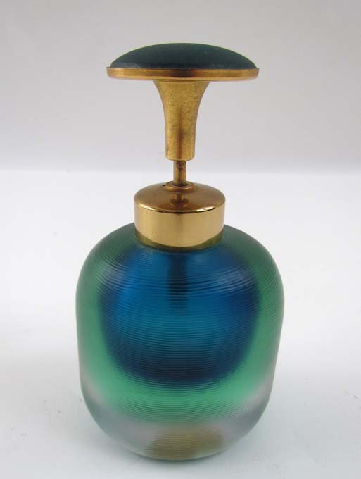 Mid-Century Modern Venini perfume bottle: Artist: Venini (Italian, 20th century) Title: Perfume bottle composed of green and blue glass encased in clear glass with a carved surface Date: c. 1950 Medium: glass Dimensions: 4.5 x 2.5 x 1 inches