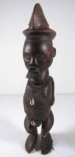 YAKA TRIBE FETISH FIGURE - with cowrie shell and some: Artist: Yaka, Congo, Central Africa Title: YAKA TRIBE FETISH FIGURE - with cowrie shell and mud decoration on stomach and lower torso Date: prior to 1949 Medium: carved wood, mud, cowrie shells Dimens