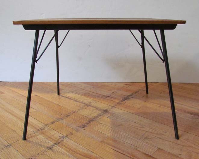 CHARLES EAMES Occasional table with folding legs: Artist: Eames, Charles and Ray Title: Occasional table with rectangular wood top on four folding metal legs. Date: mid 1950's or before Medium: Incidental table (IT), table with rectangular wood top o