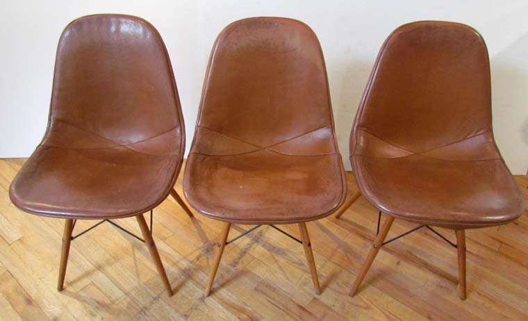 3 Eames Dowel Leg Chairs with orig leather Seat Covers: Artist: Eames, Charles and Ray Title: 3 Eames PKW Dowel Leg Chairs with original brown leather Seat Covers Date: mid 1950's Medium: wood, metal, and leather Dimensions: 32 x 22 x 19 inches Signatu