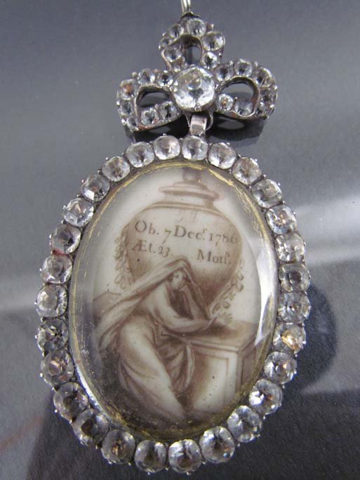 Mourning Pendant on Ivory dated 1786: Title: Pendant, mourning jewelry composed of a glass covered scene painted on ivory surrounded by paste diamonds, dated December 7, 1786 Date: 1786 Medium: ivory Dimensions: 3 inches
