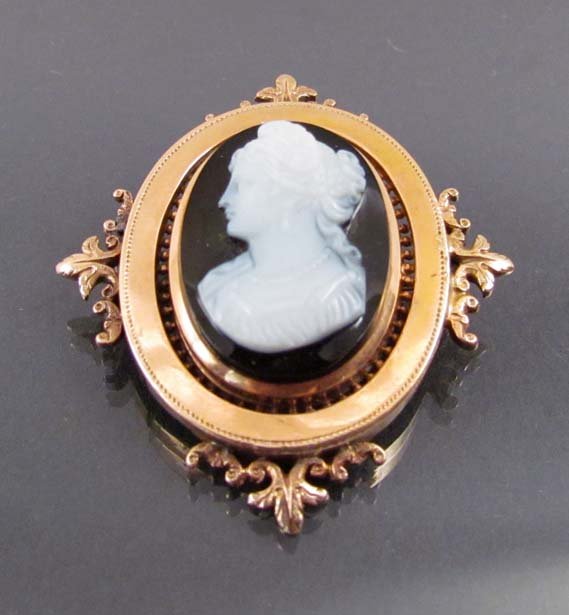 Obsidian and Rose Gold Cameo Brooch: Title: Brooch, cameo carved from obsidian showing the bust of a woman in a finely cast rose gold surround, unmarked Medium: obsidian, rose gold Dimensions: 2 inches