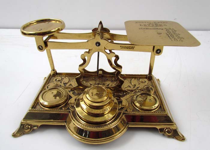 British Roberval Postal Scale c. 1897-1915: Title: British Roberval Postal Scale, dated due to postal rates engraved on its letter plate. Beam stamped Warranted, Accurate, and sets upon an open shaped A frame. Floral decorated base has three we