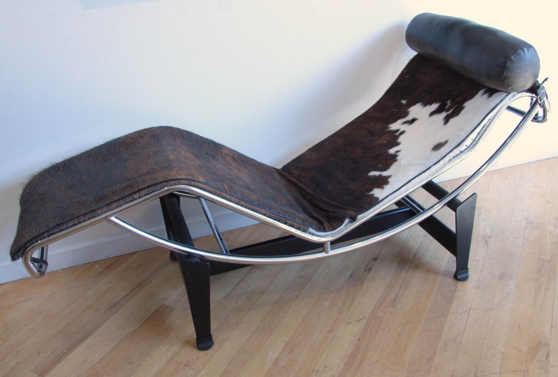 Cassina LC4 cow hide chaise lounge with leather pillow: Artist: Le Corbusier (Switzerland, 1887-1965) Title: Cassina LC4 cow hide chaise lounge with leather pillow Medium: cow hide, leather, and metal Dimensions: 27 x 62 x 23 inches Signature: "Cassina M