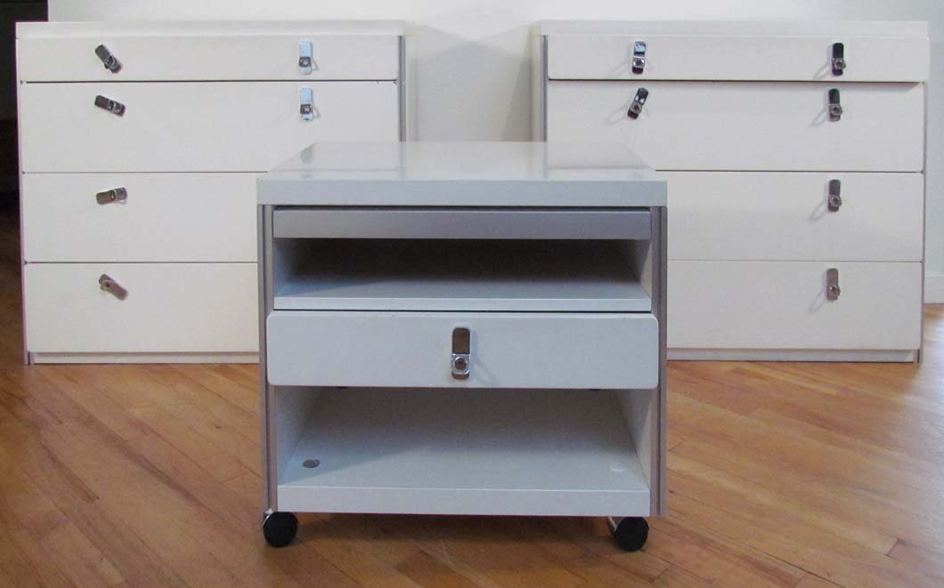Pair Modern White Laminate Dressers & Night Stand: Title: Pair White laminate Modern Custom Design Dresser Set and Nightstand with chromed pulls Dimensions: 29 x 35.25 x 17.5 inches, (Dressers) Provenance: The Estate of Jane Z. Haskell