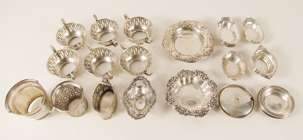 Collection of Sterling Silver Tableware: Title: Collection of Sterling Silver Tableware including small bowls, small trays, small silver surrounds, small handled basket, salt cellars, etc. Dimensions: 52.36 ozt Provenance: The Estate of Audr