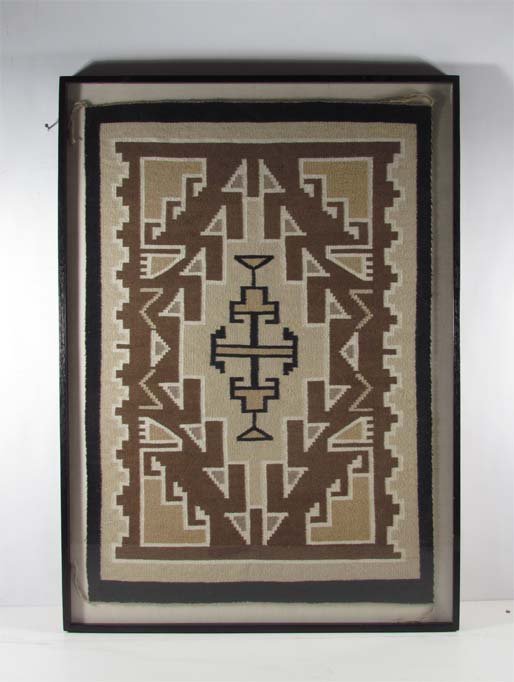 Native American Carpet: Medium: woven wool carpet Dimensions: 24 x 34.5 inches Provenance: A regional Corporation Frame Type: floated in an ebonized walnut wood frame Frame Size: 28 x 38 inches