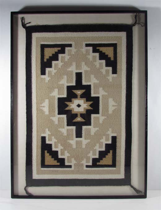 Native American Carpet: Medium: woven wool carpet Dimensions: 21.5 x 33 inches Provenance: A regional Corporation Frame Type: floated in an ebonized walnut wood frame Frame Size: 27.5 x 38 inches