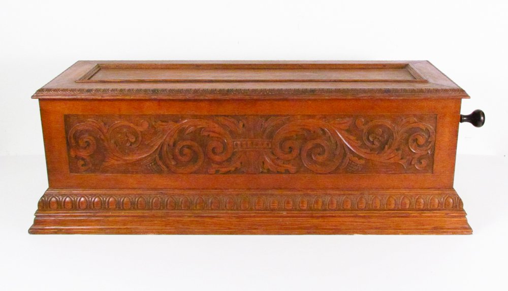 Ideal Sublime Harmonie Piccolo Swiss Music Box: Title: Ideal Sublime Harmonie Piccolo Music Box with carved oak case. Date: circa 1890 Dimensions: 13 x 39.25 x 15.25 inches Provenance: The Estate of Audrey Watkins Garbisch, Connoquenessing, Pa.